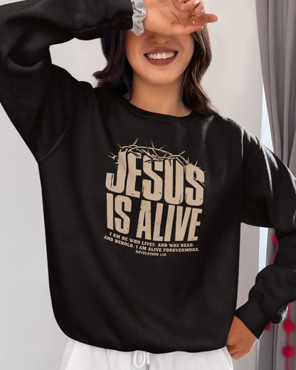 Person wearing a black sweatshirt with 'Jesus is Alive' text, smiling indoors.