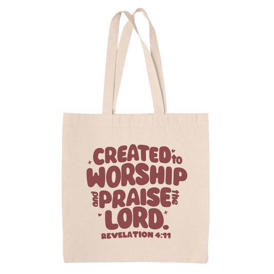 Natural Beige canvas tote bag with red text 'Created to Worship and Praise the Lord. Revelation 4:11' on a white background