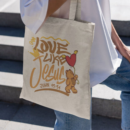 Tote bag with 'Love Like Jesus' design held by a person