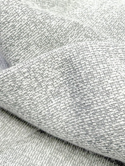 Close-up of mix stone black and white ultra soft plush knit textured fabric with a folded pattern
