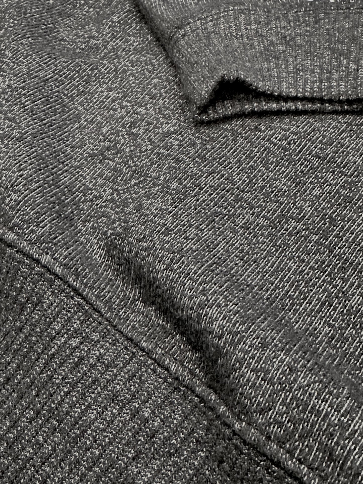 Close-up of dark grey ultra soft plush knit textured fabric with a folded pattern
