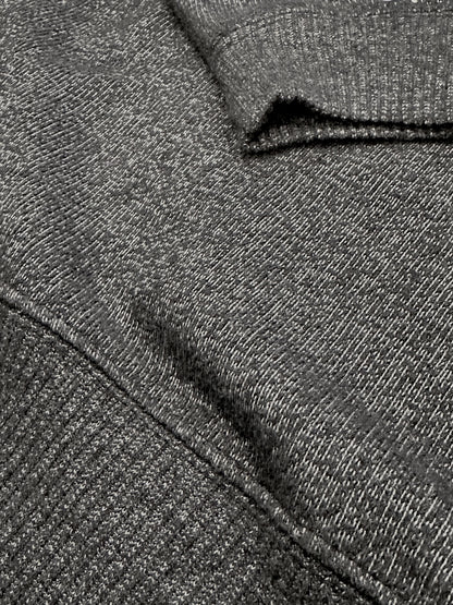 Close-up of dark grey ultra soft plush knit textured fabric with a folded pattern